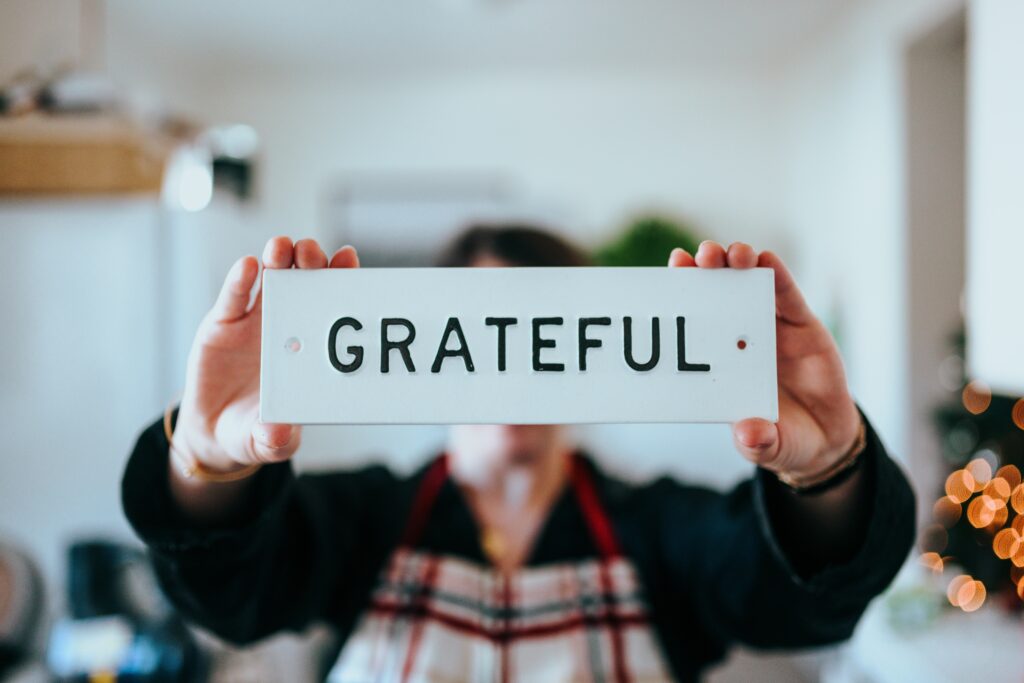 Someone holding a sign that says "Grateful"